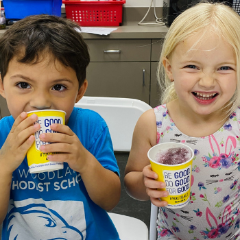 Two preschoolers enjoy shaved ice at open gym.